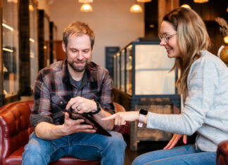 Beyond the Transaction: Empathy and Simplicity in Cannabis Retail A budtender and customer sitting on a couch in a modern dispensary, demonstrating a simplified and empathetic cannabis retail experience.