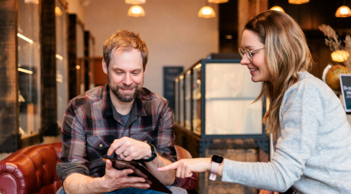 Beyond the Transaction: Empathy and Simplicity in Cannabis Retail A budtender and customer sitting on a couch in a modern dispensary, demonstrating a simplified and empathetic cannabis retail experience.