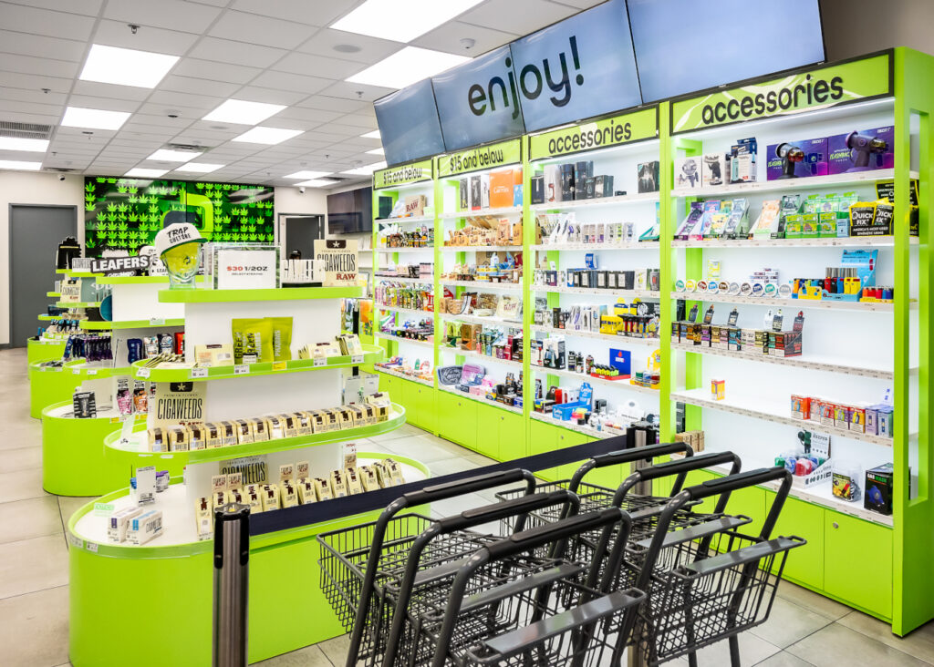Shopping carts at the entrance of GreenPharms, facing bright aisles and open shelves.