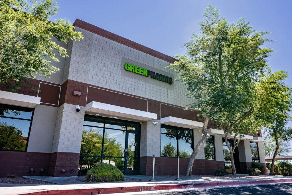 Exterior of the GreenPharms building in Mesa, Arizona, with the GreenPharms sign above the entrance.