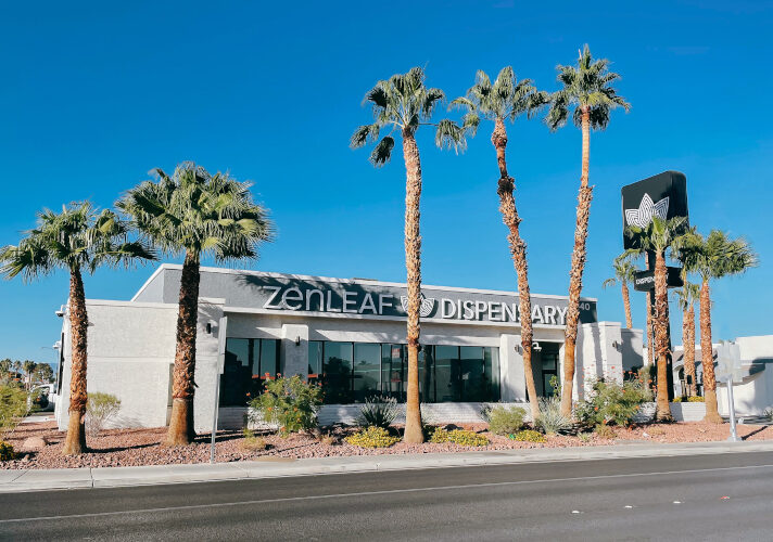 Zen Leaf dispensary exterior with palm trees and street frontage, showing a bright, desert-market setting.