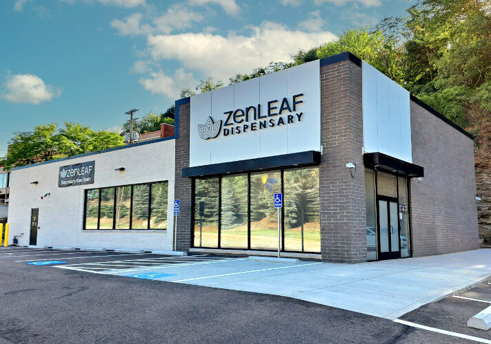 Zen Leaf dispensary exterior with prominent signage and a parking lot in front of the building at dusk.