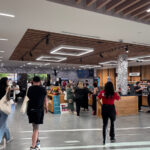 The Retail Design Playbook Behind Zen Leaf’s Multi-State Consistency Customers browse product displays inside a Zen Leaf dispensary with warm wood fixtures and modern overhead lighting.