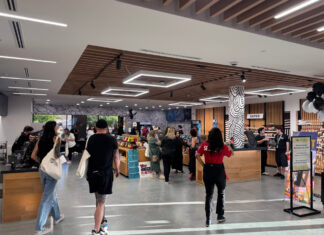 The Retail Design Playbook Behind Zen Leaf’s Multi-State Consistency Customers browse product displays inside a Zen Leaf dispensary with warm wood fixtures and modern overhead lighting.
