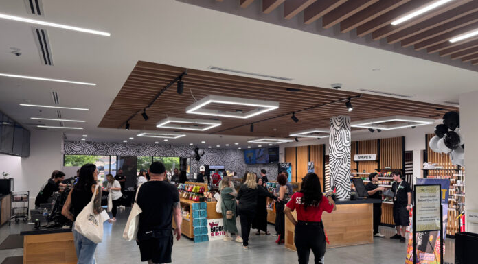 The Retail Design Playbook Behind Zen Leaf’s Multi-State Consistency Customers browse product displays inside a Zen Leaf dispensary with warm wood fixtures and modern overhead lighting.