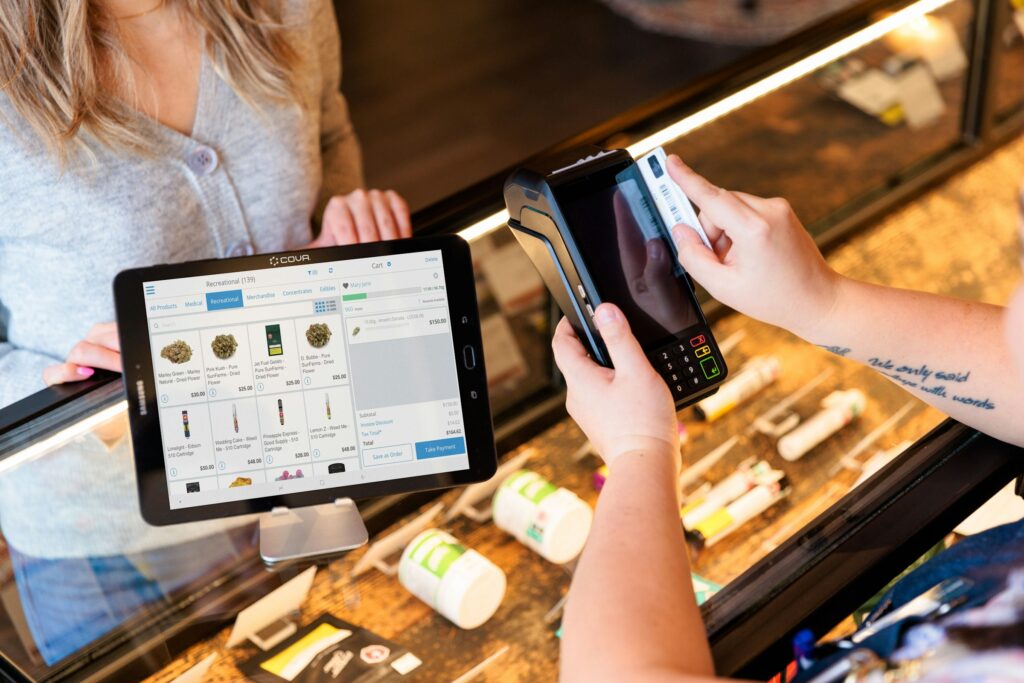 A close-up of a retail transaction being processed quickly on a Cova POS tablet in a dispensary.