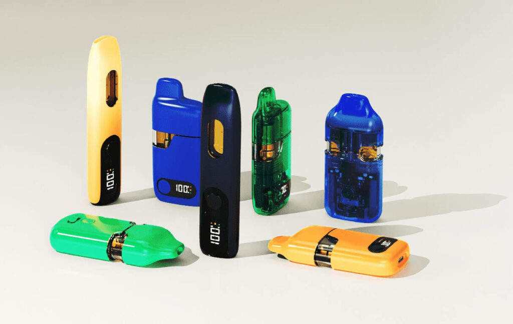 Lineup of brightly colored Greentank disposable vape devices arranged on a light background, showing different finishes and styles.
