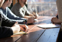 How Cannabis Operators Can Win in a Post-280E Market Cannabis business operators discussing strategy and financial planning at a meeting table.