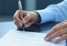 Kiva Sales & Service, Petalfast Sign Deal to Combine man's hand signing a contract