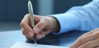 Kiva Sales & Service, Petalfast Sign Deal to Combine man's hand signing a contract