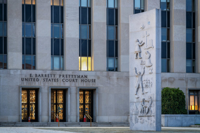 Exterior of the United States Court of Appeals for the D.C. Circuit in Washington, D.C., photographed under overcast light. The neoclassical façade with tall stone columns conveys the gravity of federal judicial review.