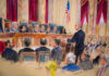 Who Will Argue Against Cannabis Rescheduling at DEA’s June Hearing? Editorial illustration of a federal hearing on DEA cannabis rescheduling with officials, attorneys, and audience members in a formal courtroom setting.