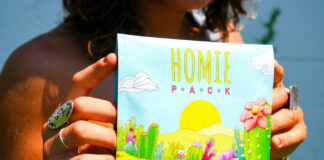 Opinion: Why Cannabis Brands Should Champion Original Art A person holds a colorful illustrated package featuring original cactus-and-flower artwork.