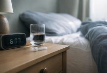 Small Study Links Frequent Cannabis Use to Higher Waking Cortisol Saliva collection tube beside a clock and water glass in early morning light