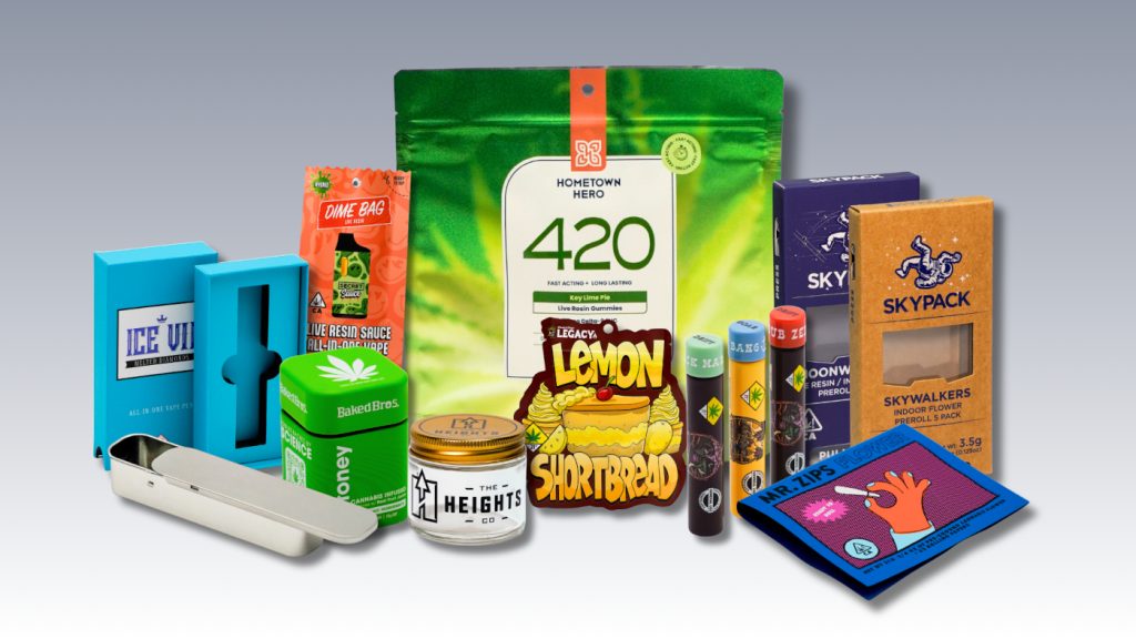 Assorted cannabis packages including boxes, pouches, tins, and a branded shopping bag.