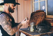 The Cannabis Industry Is Optimizing the Wrong Thing Sean Oganesyan examines cannabis flower at a wooden workbench.