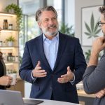 Rethinking Healthcare Benefits for Cannabis Employers Business professionals discussing healthcare benefits during an office meeting