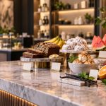 Cannabis Is Learning to Speak Consumer Flavor-inspired foods arranged like products on an upscale retail counter, illustrating changing cannabis naming and merchandising trends.
