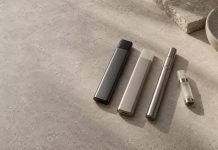 Unbranded integrated vaporizers beside a reusable battery and cartridge.