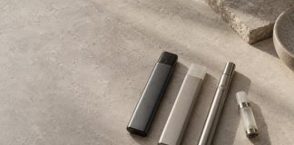 Unbranded integrated vaporizers beside a reusable battery and cartridge.