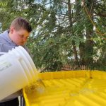 DENIOS Helps Symonds Elementary School with Maple Sugaring Project student-pours-maple-sap-into-denios-funnel
